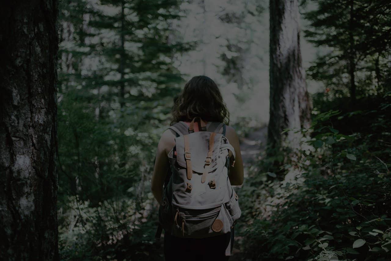 hiker in the woods with backpack